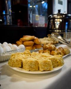 a plate of food on a table with pastries and eggs at Hotel "CONTINENT" halal in Karagandy