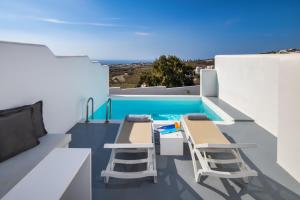 a balcony with chairs and a swimming pool at Alunia Incognito Suites - Adults Only in Pirgos