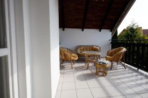 a patio with chairs and a table on a balcony at Holiday home Jarzębinowa in Rowy