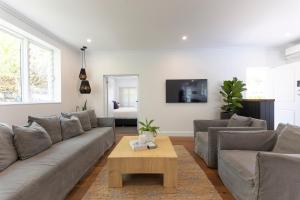 a living room with a couch and a coffee table at Nala Cottage at Patonga in Patonga Beach