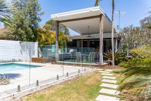 a house with a swimming pool and a pavilion at Nala Cottage at Patonga in Patonga Beach