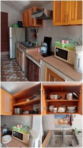 uma cozinha com armários de madeira e um lavatório em แดดดี้ โฮมสเตย์ สัตหีบ em Ban Tao Than