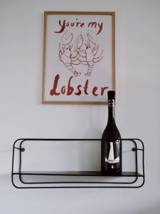 a glass shelf with a bottle of wine on it at Boutique Wine and Wellness Retreat - Wine Residence Kerman in Štrigova