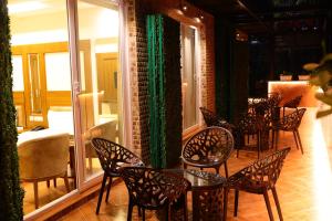 a group of chairs and tables on a balcony at Karon Hotels - Lajpat Nagar in New Delhi