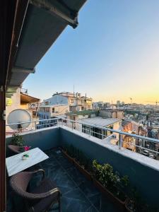 a balcony with a table and chairs on top of a building at La Serena Taksim in Istanbul