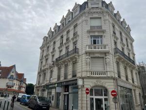 a large white building on a city street at Eole in Wimereux
