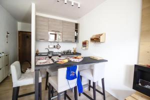 a kitchen with a table and chairs in a room at Casa Franz in Val di Fassa by Zoom In Earth in Mazzin +19 photos