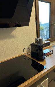 a desk with a computer on it with a window at K-Business-Apartments in Oberesslingen