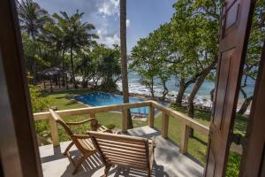 a balcony with two chairs and a view of the ocean at South Point Abbey in Ahangama