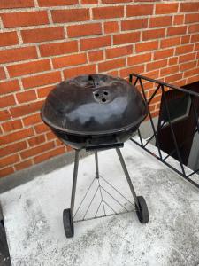 a charcoal grill sitting in front of a brick wall at Room B in Malmö