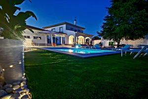 un patio trasero con piscina y una casa en La casa del árbol, en Fuentidueña de Tajo