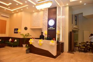 a lobby with a reception desk with a clock on a wall at Hotel Royal Altis in Vasco Da Gama