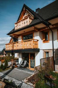 a large house with a balcony on top of it at Mountain Base - Dom Hrabiego in Zakopane