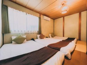 A bed or beds in a room at *Fortune House*動物園前站只要步行2分鐘 日式一户建 可6人入住