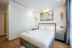 1 dormitorio con 1 cama blanca grande en una habitación en Vera Saigon Apartments - Vinhomes Central Park, en Ho Chi Minh