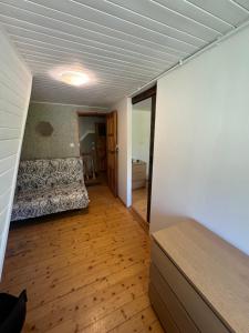 a room with a bed and a room with a wooden floor at Willa Zacisze Karpacz in Karpacz