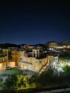 a view of a city at night at Cordoba Suites in Hurghada
