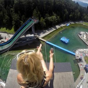 a girl on a zip line over a water slide at Ferienwohnung Ache in Oetz