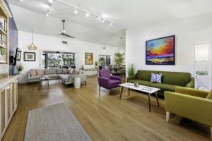 a living room with green and purple furniture at Dancing Dolphin home in Captiva