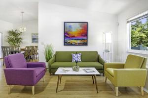 a living room with green and purple chairs and a table at Dancing Dolphin home in Captiva