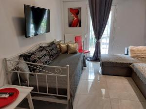 a living room with a bed and a couch at Kabana Suite Thessaloniki in Thessaloniki