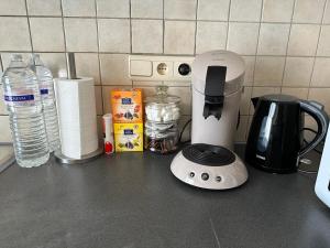 a counter top with a coffee maker and a blender at Bnb Antwerp SportPlaza in Antwerp
