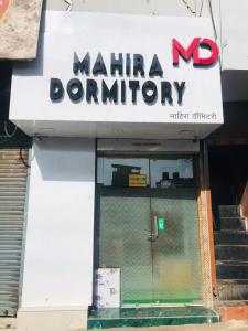 a sign for a marina donut shop with a door at New Mahira Dormitory in Mumbai