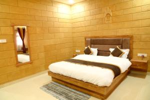 a bedroom with a bed and a mirror at The Travel Bug Jaisalmer in Jaisalmer