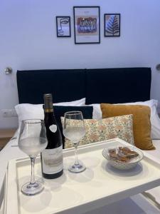 a table with two glasses and a bottle of wine at Ikarus Rhodes Center in Rhodes Town