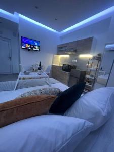 a living room with two beds and a kitchen at Ikarus Rhodes Center in Rhodes Town