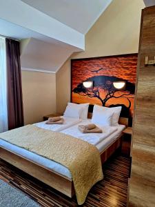 a hotel room with a bed with a head board at Angyal Apartman Gyula in Gyula