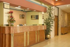 a lobby with a reception counter in a hospital at Ramada by Wyndham Los Angeles/Wilshire Center in Los Angeles