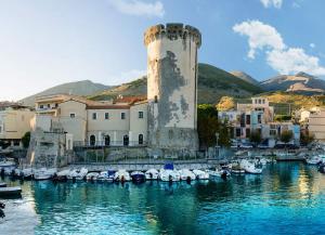 a group of boats in a marina with a tower at Casa Vacanze Formia in Formia