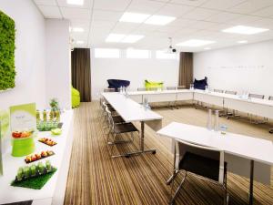 a classroom with tables and chairs in a room at Novotel Genève Centre in Geneva