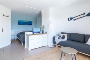 a living room with a couch and a bed at Haus Seeblick Wohnung 12 Easy Ocean in Wohlenberg