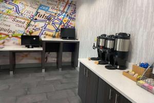 a coffee shop with two coffee machines on a counter at La Quinta Inn & Suites by Wyndham Tulsa Midtown in Tulsa