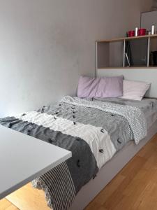 a bed in a room with a table at Lovely Big Studio for two in Munich