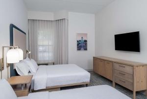 a hotel room with a bed and a flat screen tv at Homewood Suites by Hilton Montgomery - Newly Renovated in Montgomery