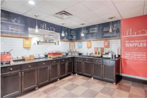 a kitchen with wooden cabinets in a restaurant kitchen at Hampton Inn Washington Court House in Jeffersonville