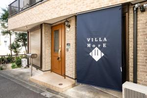 a building with a sign that reads villa motel at VILLA MorE in Tokyo