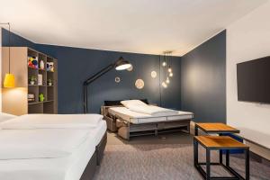 Postel nebo postele na pokoji v ubytování Vienna House Easy by Wyndham Trier