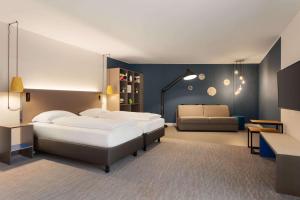 Postel nebo postele na pokoji v ubytování Vienna House Easy by Wyndham Trier