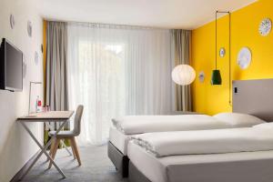 Postel nebo postele na pokoji v ubytování Vienna House Easy by Wyndham Trier