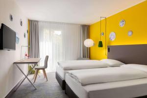 Postel nebo postele na pokoji v ubytování Vienna House Easy by Wyndham Trier