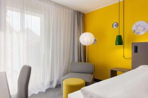 Postel nebo postele na pokoji v ubytování Vienna House Easy by Wyndham Trier