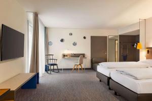 Postel nebo postele na pokoji v ubytování Vienna House Easy by Wyndham Trier