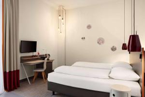 Postel nebo postele na pokoji v ubytování Vienna House Easy by Wyndham Trier