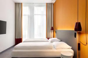 Postel nebo postele na pokoji v ubytování Vienna House Easy by Wyndham Trier