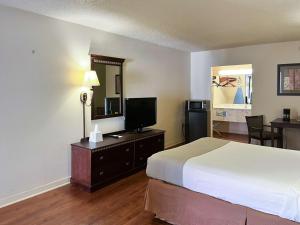 a hotel room with a bed and a television at Motel 6 Abbeville, AL in Abbeville