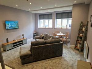 a living room with a couch and a table at The County in Newton Aycliffe